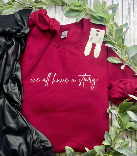 Embroidered We All Have A Story Sweatshirt Garnet Red *PREORDER*